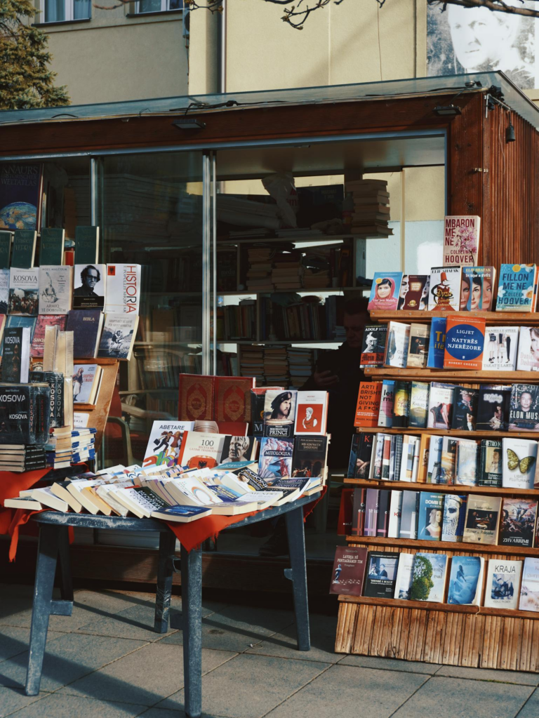 A captivating outdoor bookstand with a variety of books on display, perfect for book lovers.