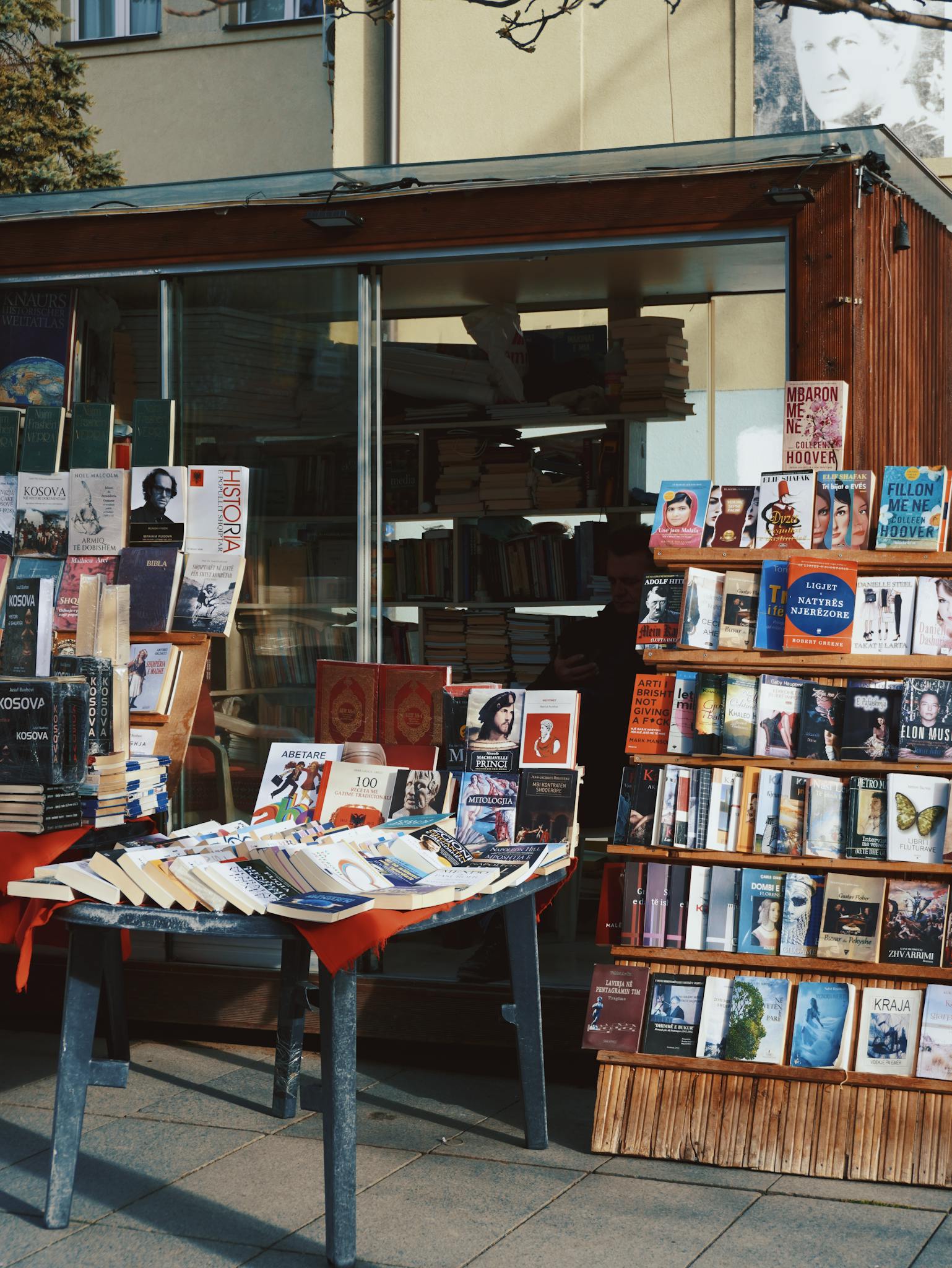 A captivating outdoor bookstand with a variety of books on display, perfect for book lovers.